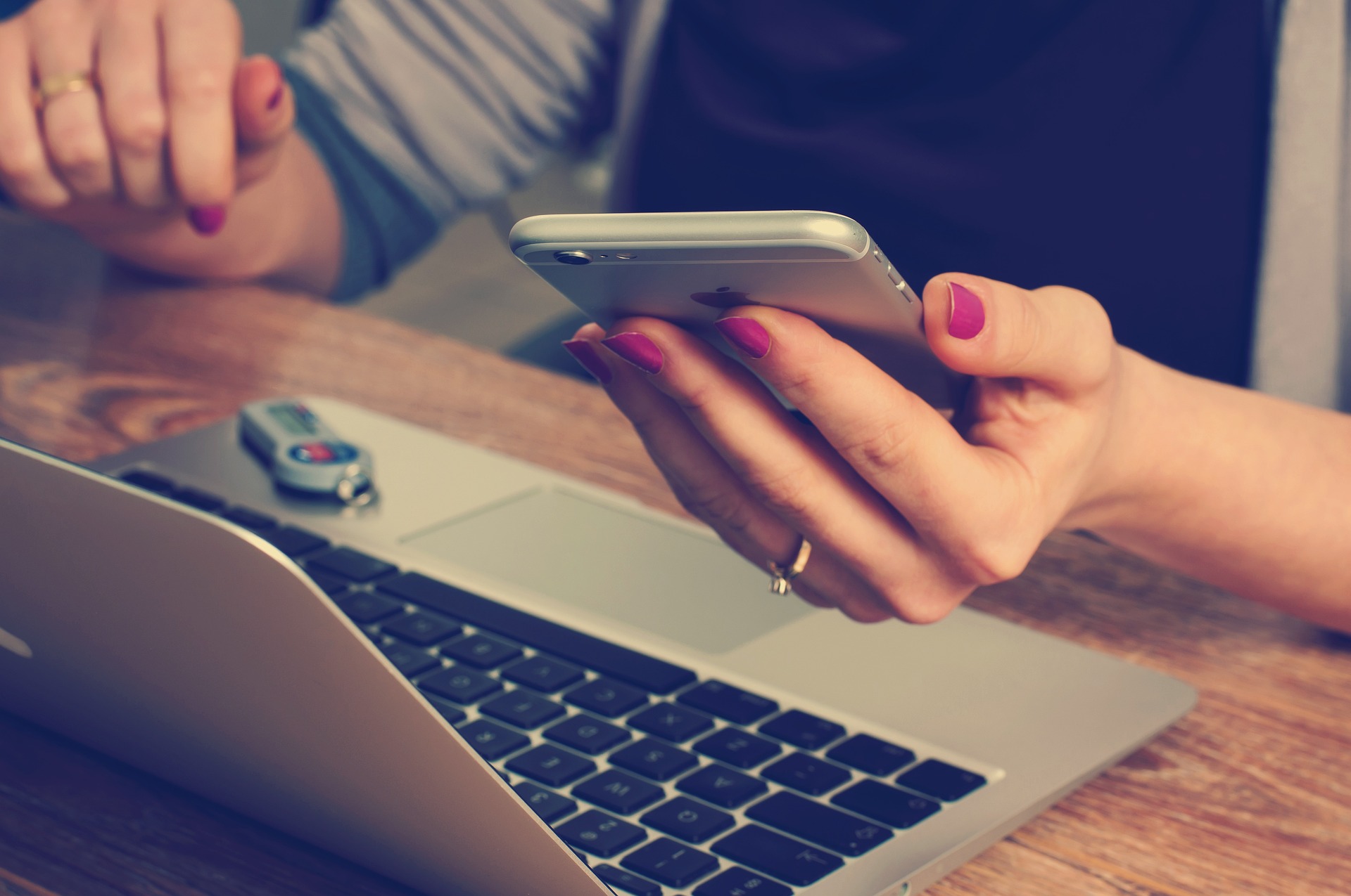 Photo of an office worker checking her phone in between tasks